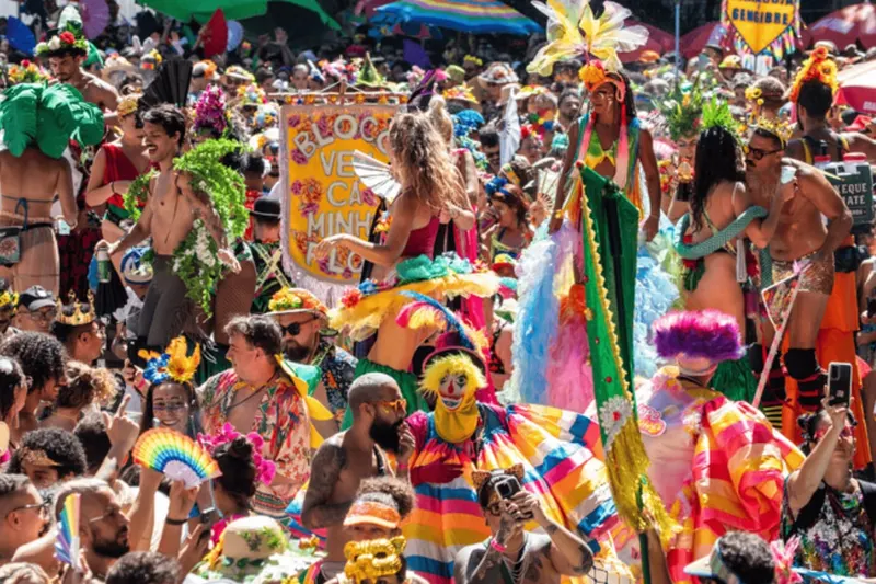 A packed, colourful street party crowd in carnival costumes